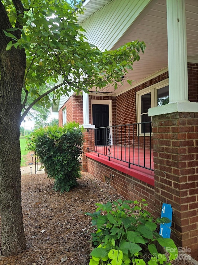 view of side of home with covered porch