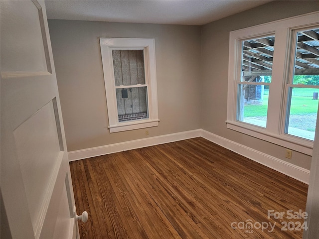 unfurnished room with hardwood / wood-style flooring