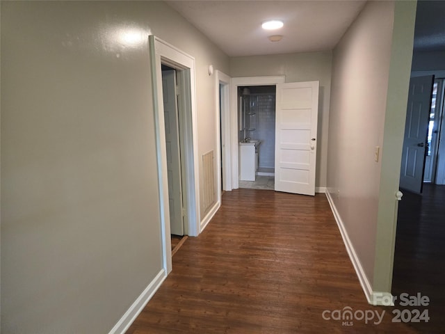 hall with dark wood-type flooring