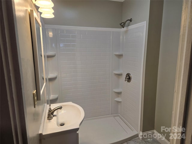 bathroom featuring walk in shower and vanity