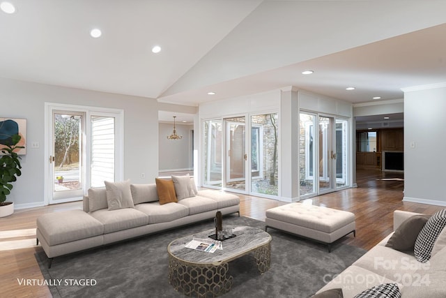 living room with high vaulted ceiling, a notable chandelier, and dark hardwood / wood-style flooring