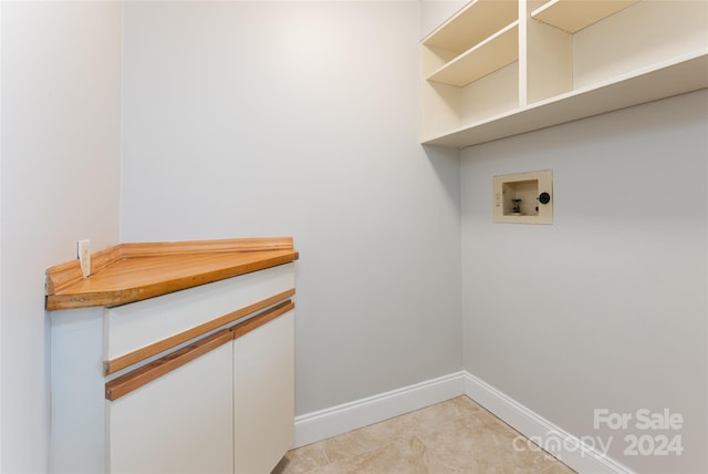 laundry room with light tile floors and hookup for a washing machine