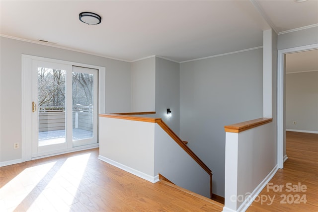 hall featuring light hardwood / wood-style floors and crown molding