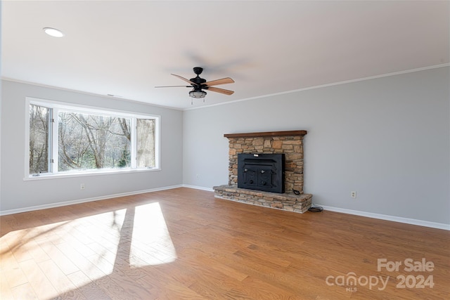 unfurnished living room with crown molding, ceiling fan, light hardwood / wood-style flooring, and a fireplace