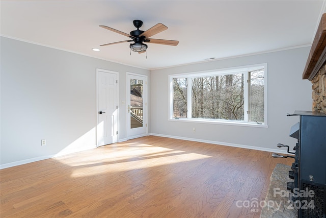 unfurnished living room featuring hardwood / wood-style flooring, ornamental molding, and ceiling fan