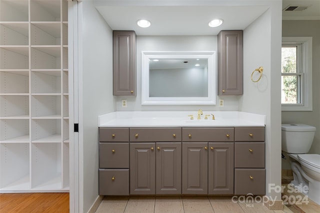 bathroom with tile flooring, oversized vanity, and toilet