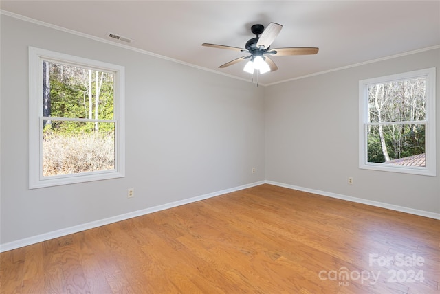 spare room with ceiling fan, crown molding, and hardwood / wood-style flooring