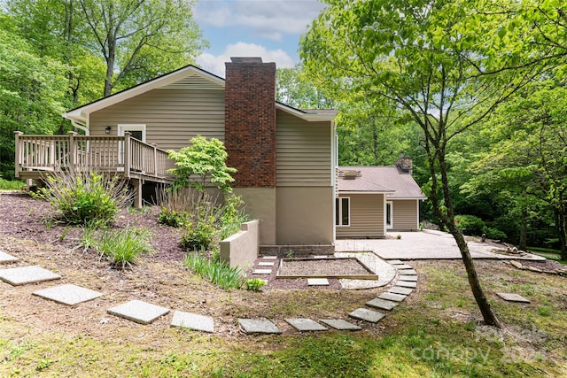 back of property featuring a deck