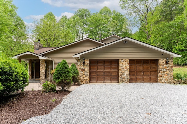 380 Old Powell Rd, Brevard, NC 28712 - view of front of house with stone siding, driveway, a chimney, and a garage