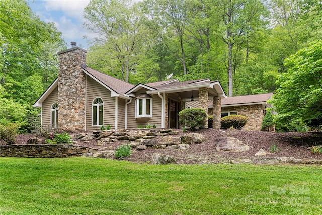 380 Old Powell Rd, Brevard, NC 28712 - view of front facade featuring stone siding, a chimney, a front lawn, and a shingled roof