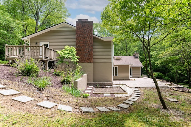 380 Old Powell Rd, Brevard, NC 28712 - rear view of house featuring a patio, a wooden deck, and a chimney