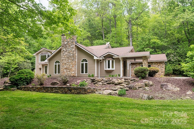 380 Old Powell Rd, Brevard, NC 28712 - view of front of house featuring a forest view, roof with shingles, a chimney, and a front yard