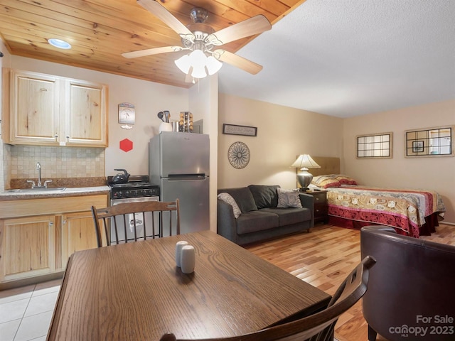 dining area with ceiling fan, wood ceiling, sink, and light wood-type flooring