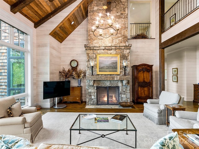 616 Old Growth Forest Rd, Burnsville, NC 28714 - living room with high vaulted ceiling, wood walls, a stone fireplace, and wood ceiling