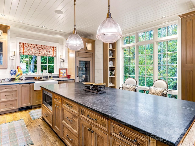 616 Old Growth Forest Rd, Burnsville, NC 28714 - kitchen featuring dark countertops, a sink, stainless steel microwave, wine cooler, and light wood-style flooring