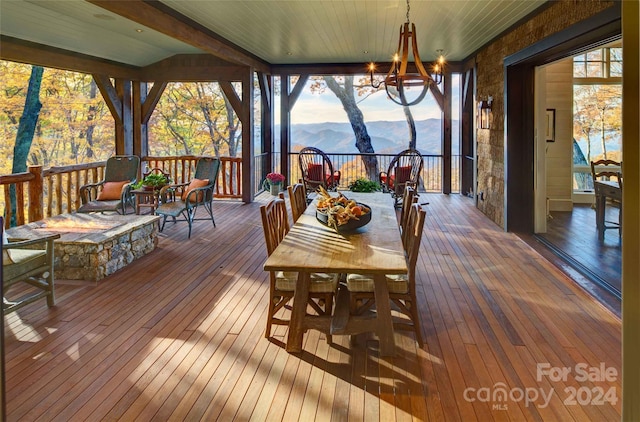 616 Old Growth Forest Rd, Burnsville, NC 28714 - exterior space with a deck with mountain view, wood-type flooring, and a chandelier