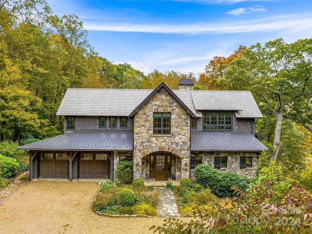 616 Old Growth Forest Rd, Burnsville, NC 28714 - view of front of house featuring a chimney, dirt driveway, stone siding, and metal roof