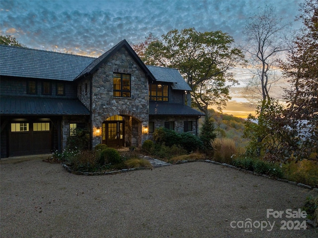 616 Old Growth Forest Rd, Burnsville, NC 28714 - view of front of home with a standing seam roof, a garage, metal roof, and stone siding