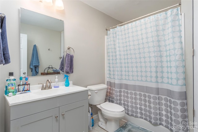 bathroom with tile flooring, vanity with extensive cabinet space, and toilet