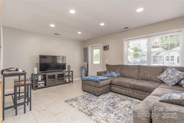 living room featuring baseboards, visible vents, and recessed lighting