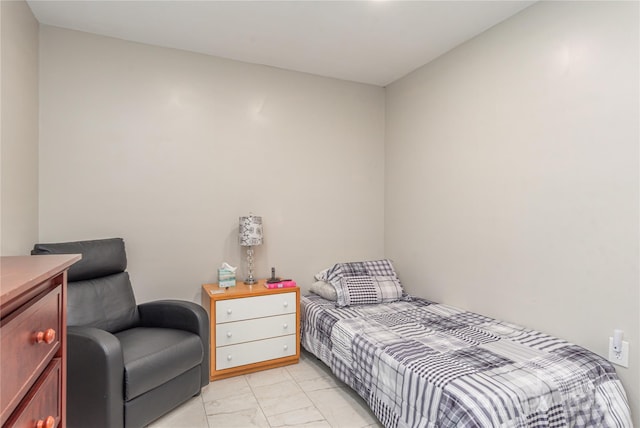 bedroom featuring marble finish floor