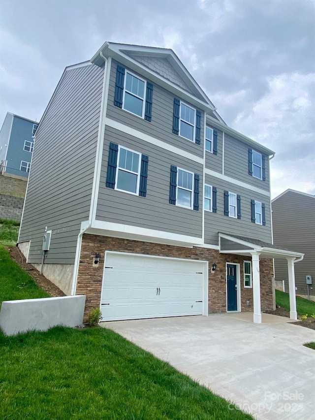 view of front of property featuring a garage and a front yard