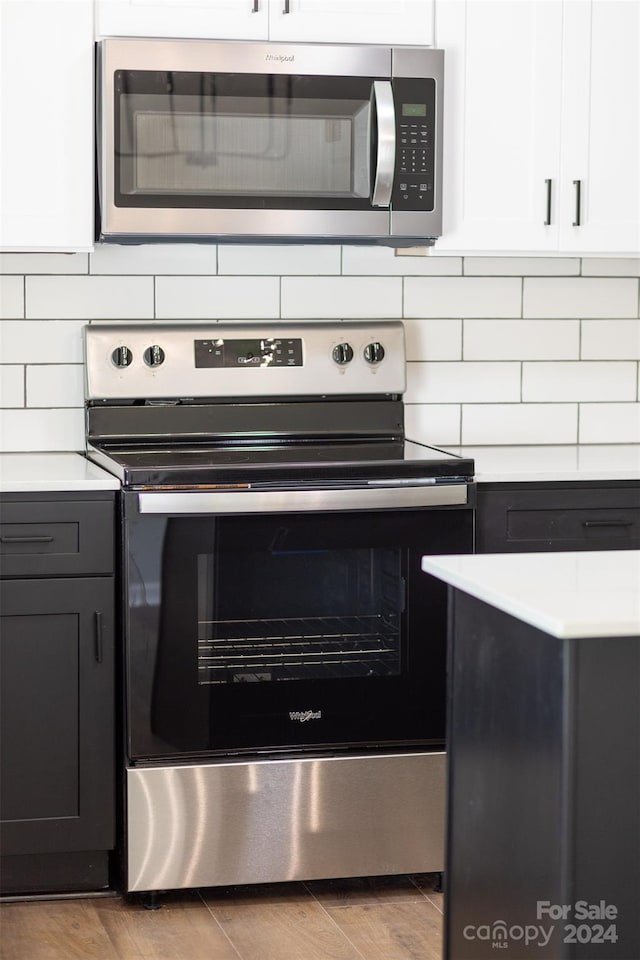 kitchen featuring white cabinets, light hardwood / wood-style flooring, and stainless steel appliances