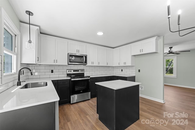 kitchen with sink, a center island, stainless steel appliances, and plenty of natural light