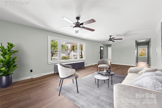 living room with hardwood / wood-style floors and ceiling fan