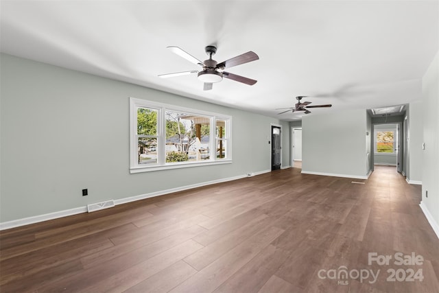 unfurnished living room featuring hardwood / wood-style flooring and ceiling fan