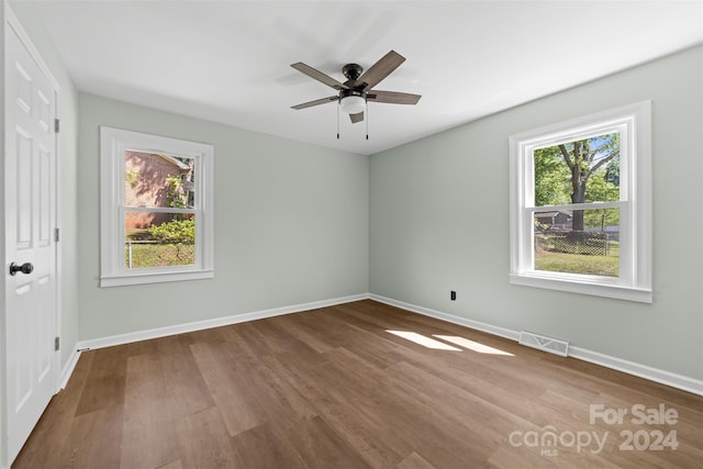 unfurnished room with hardwood / wood-style flooring and ceiling fan