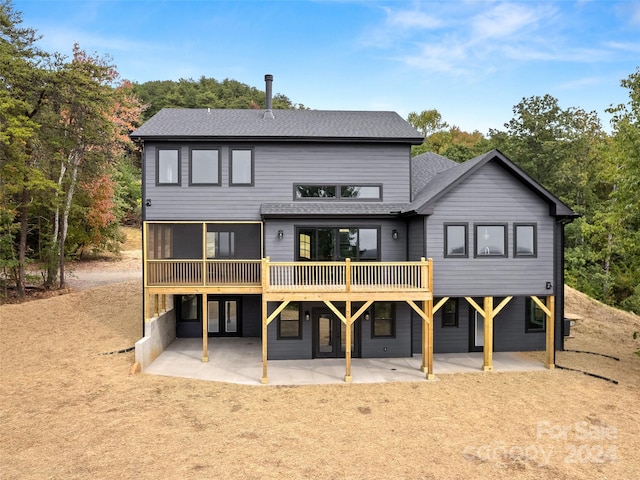 back of property featuring a patio area and a deck