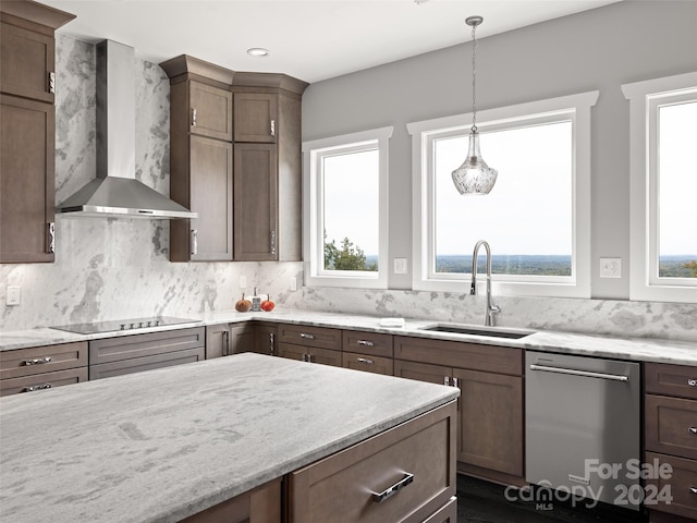 kitchen with sink, stainless steel dishwasher, wall chimney exhaust hood, black electric cooktop, and decorative light fixtures