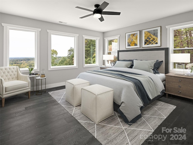 bedroom with dark hardwood / wood-style floors, ceiling fan, and multiple windows