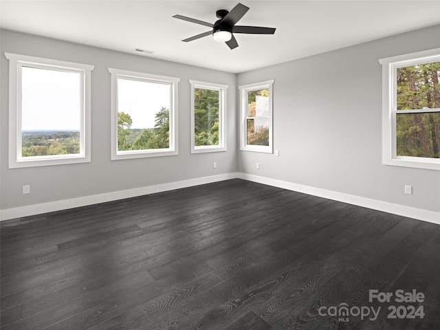 empty room featuring ceiling fan and dark wood-type flooring