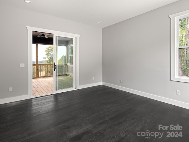 unfurnished room featuring ceiling fan and dark hardwood / wood-style floors