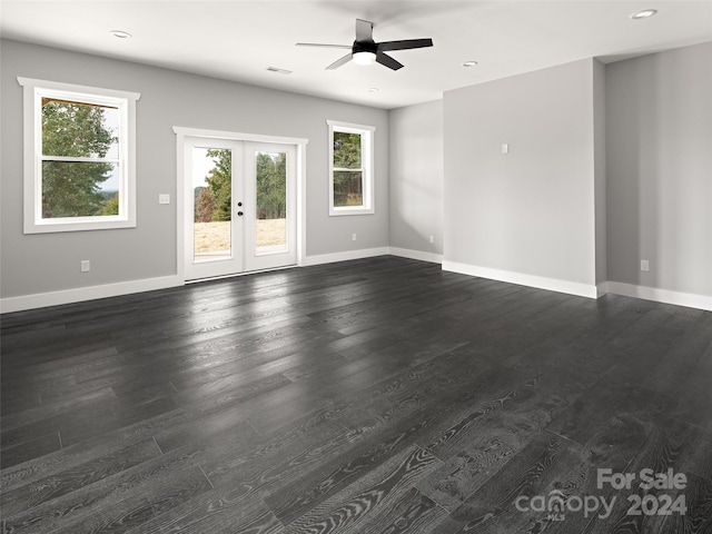 spare room featuring french doors, plenty of natural light, and dark hardwood / wood-style floors