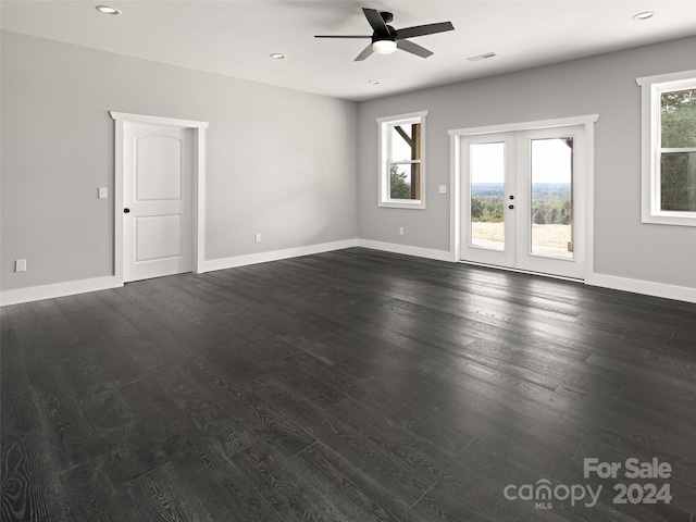 empty room featuring ceiling fan, french doors, and dark hardwood / wood-style floors