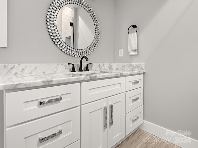 bathroom featuring vanity and hardwood / wood-style flooring