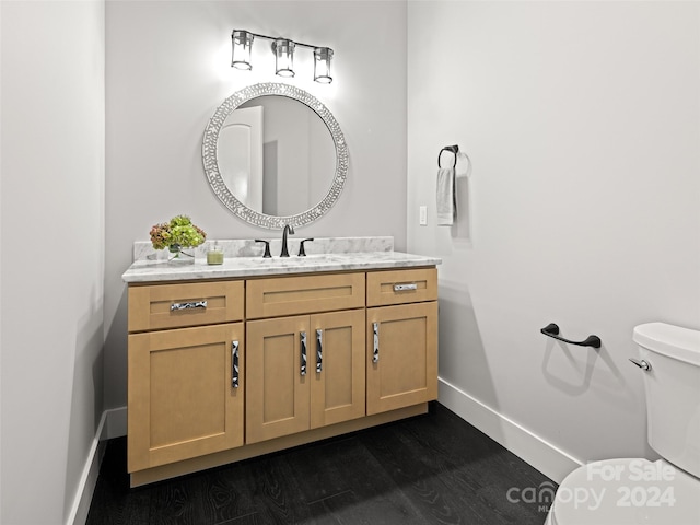 bathroom featuring hardwood / wood-style floors, vanity, and toilet