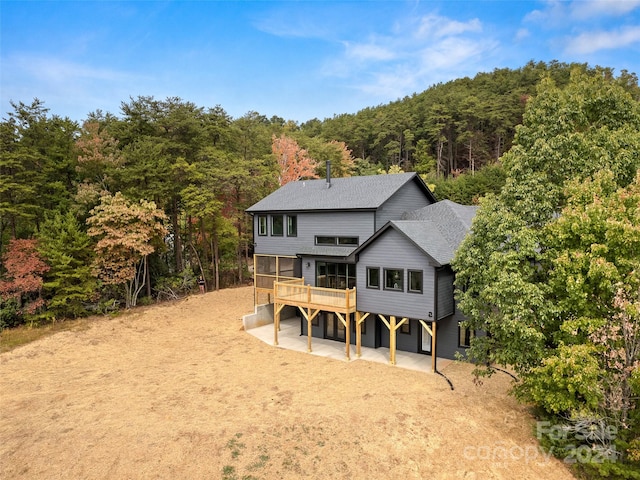 back of house featuring a patio area and a wooden deck