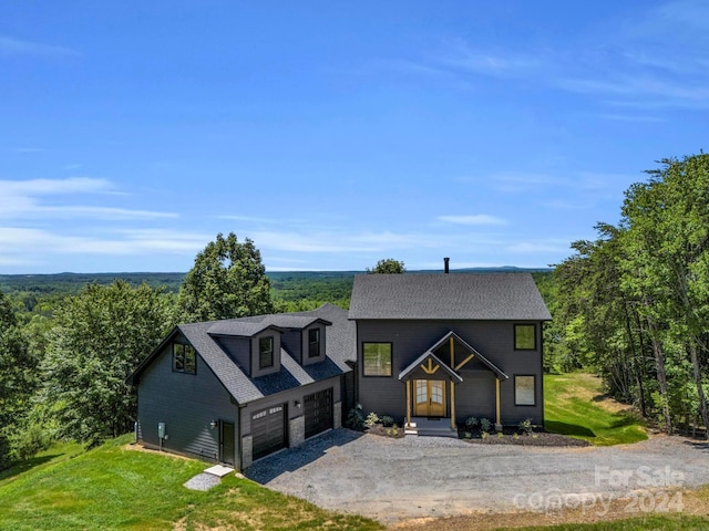 view of front of house featuring a front yard and a garage