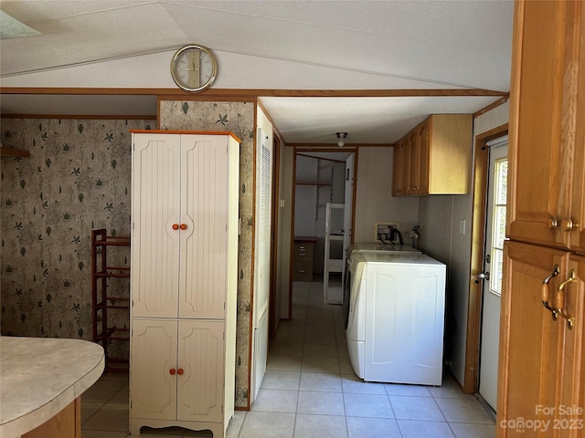 laundry room featuring washer / dryer, cabinets, light tile patterned flooring, and a textured ceiling