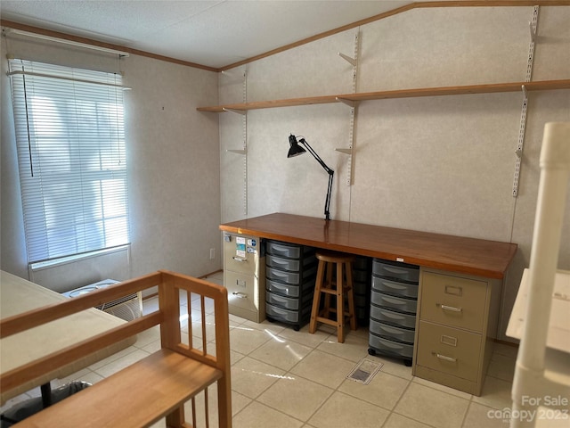 office area with ornamental molding, a textured ceiling, light tile patterned floors, and bar