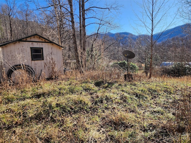 exterior space with a mountain view and an outbuilding