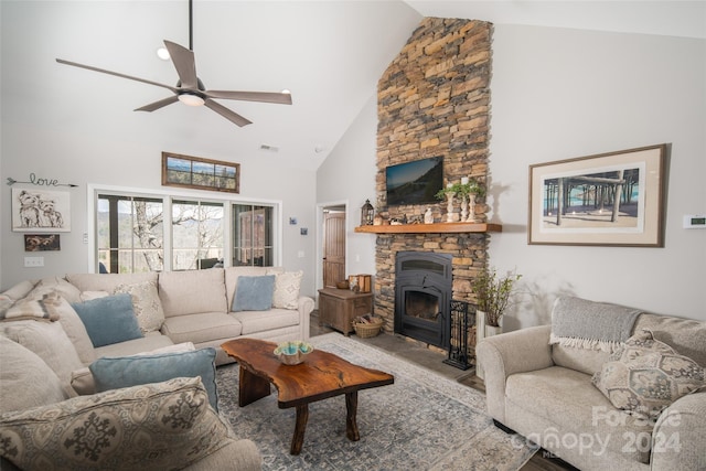 living room featuring high vaulted ceiling, ceiling fan, and a stone fireplace