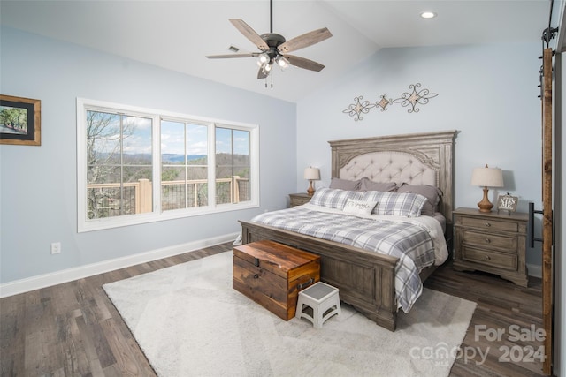 bedroom featuring dark hardwood / wood-style floors, lofted ceiling, and ceiling fan