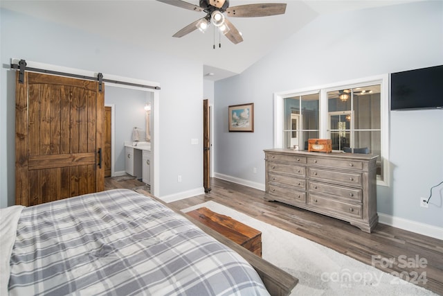 bedroom featuring high vaulted ceiling, a barn door, ensuite bath, ceiling fan, and dark wood-type flooring