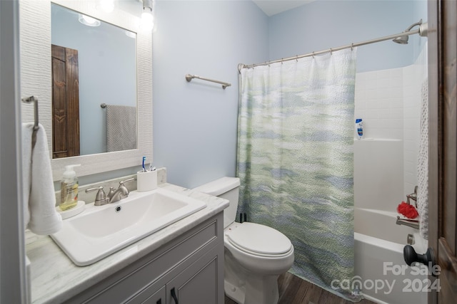 full bathroom featuring hardwood / wood-style flooring, shower / tub combo, toilet, and large vanity