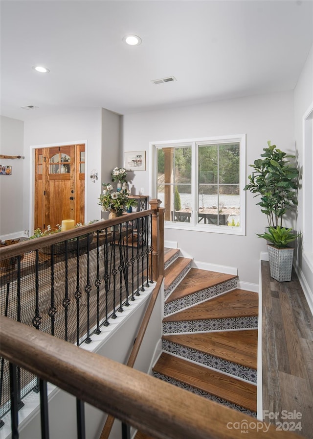 staircase featuring dark hardwood / wood-style floors